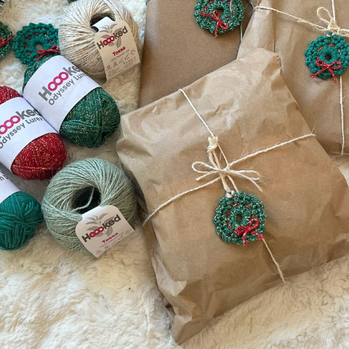Eco-friendly Christmas gift wrapping with kraft paper, jute tossa, and crochet wreaths made with Hoooked yarns